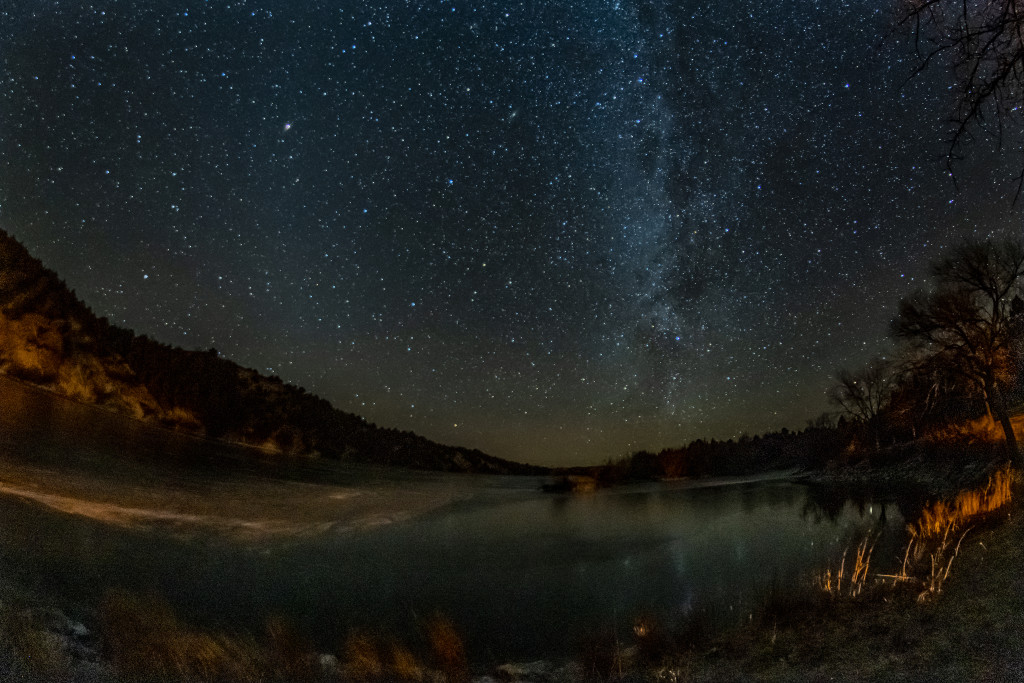 The Milky Way glows in the night sky and reflect off of Merritt Reservoir.