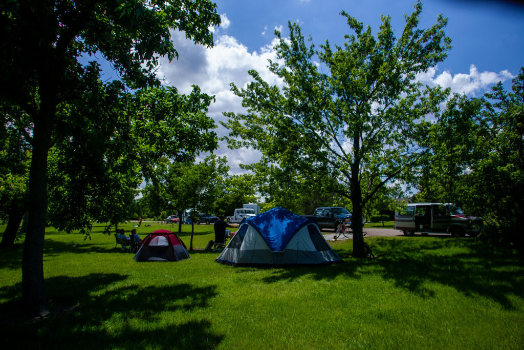 tent campers relax in the shade at the campground