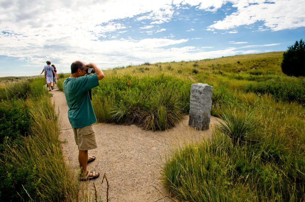 A family walks along the Oregon Trail at Windlass Hill in Nebraska