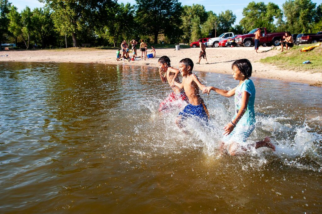 Children run, splash, and play at the swim beach.