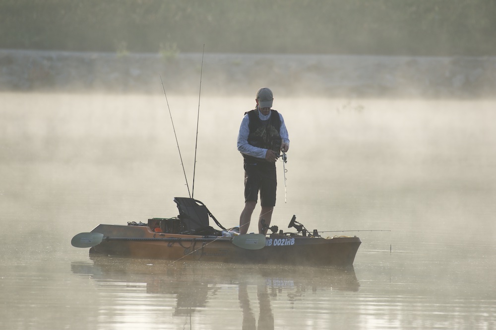 man fishes from a kayak on a foggy morning at Conestoga SRA