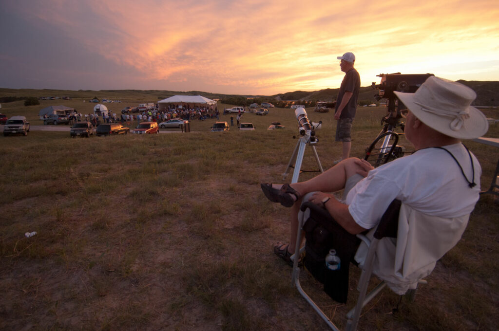 A man sits in a lawn chair as the sun sets at the Nebraska Star Party at Merritt Reservoir.