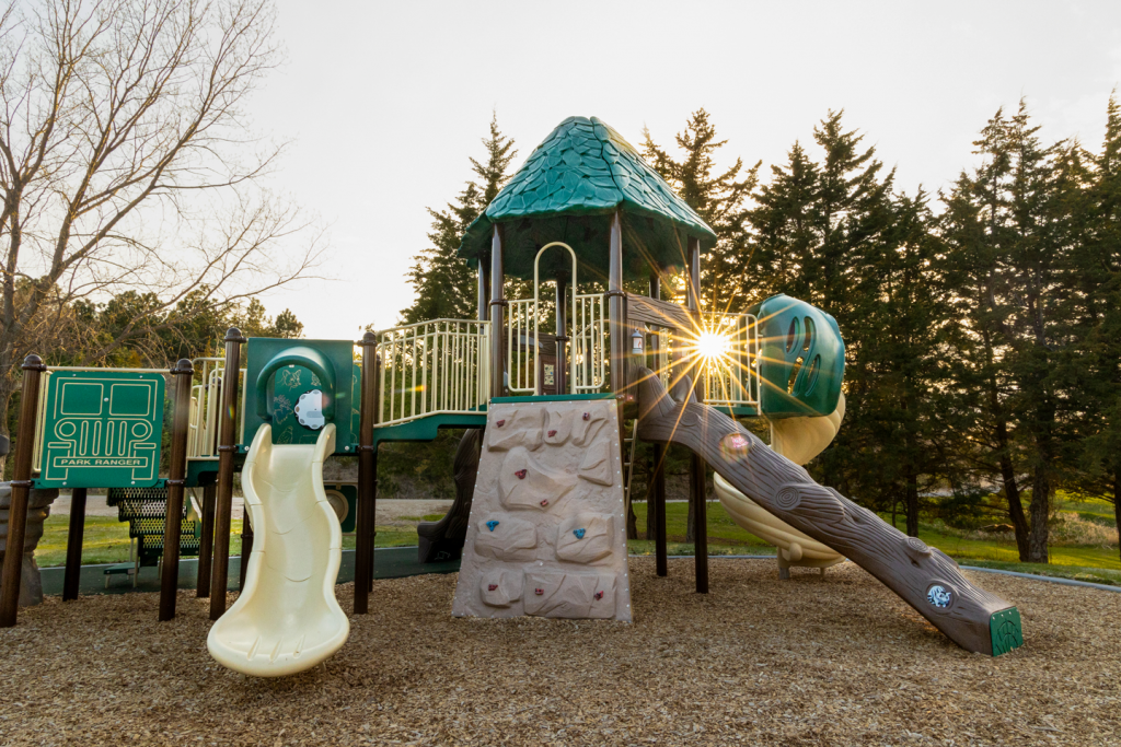 the sun peeks through a playset