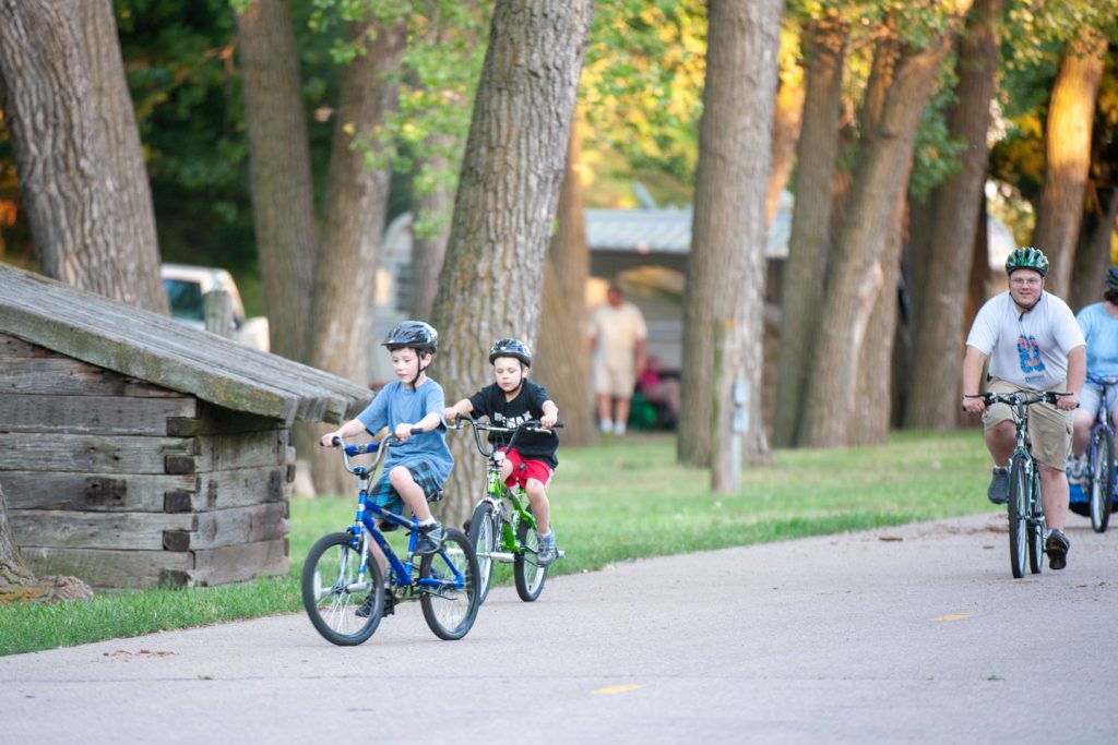 Two boys riding bikes along a trail