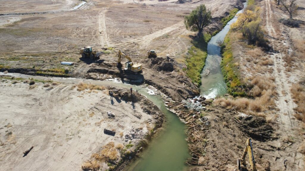 Aerial shot showing construction on a creek.