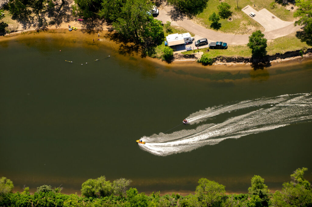 A personal watercraft pulls a ski tube on a lake at Fremont Lakes SRA.