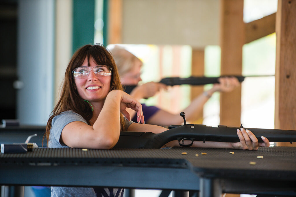 A woman smiles after shooting rounds at Wildcat Hills shooting complex.