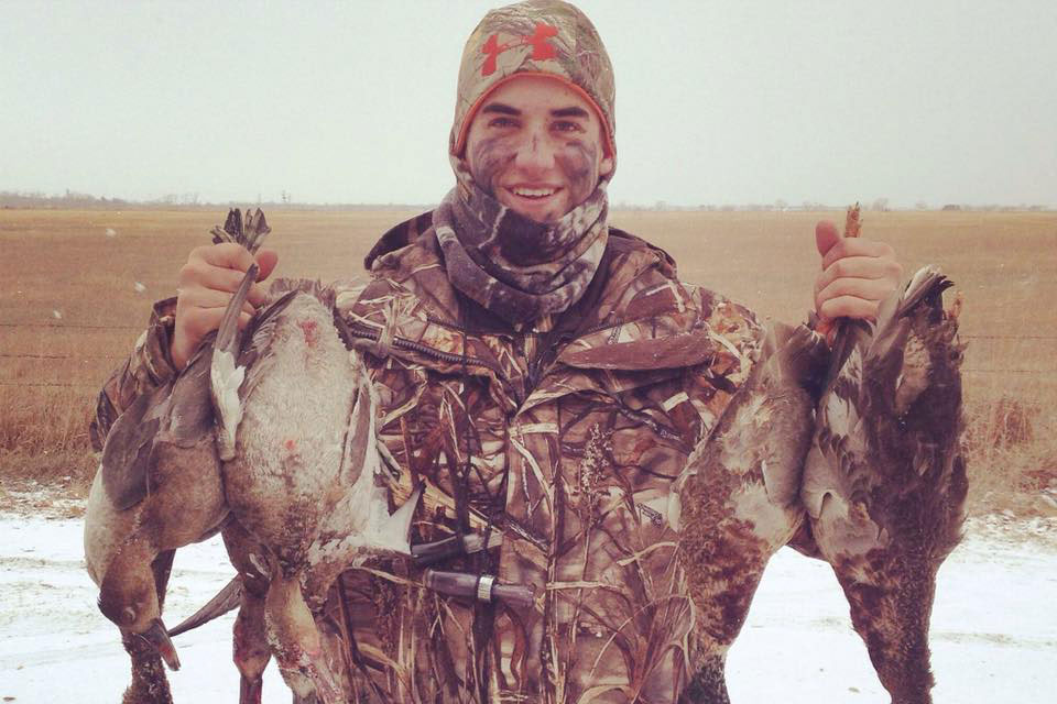 Tyler Vanderheiden in hunting garb holding ducks he harvested