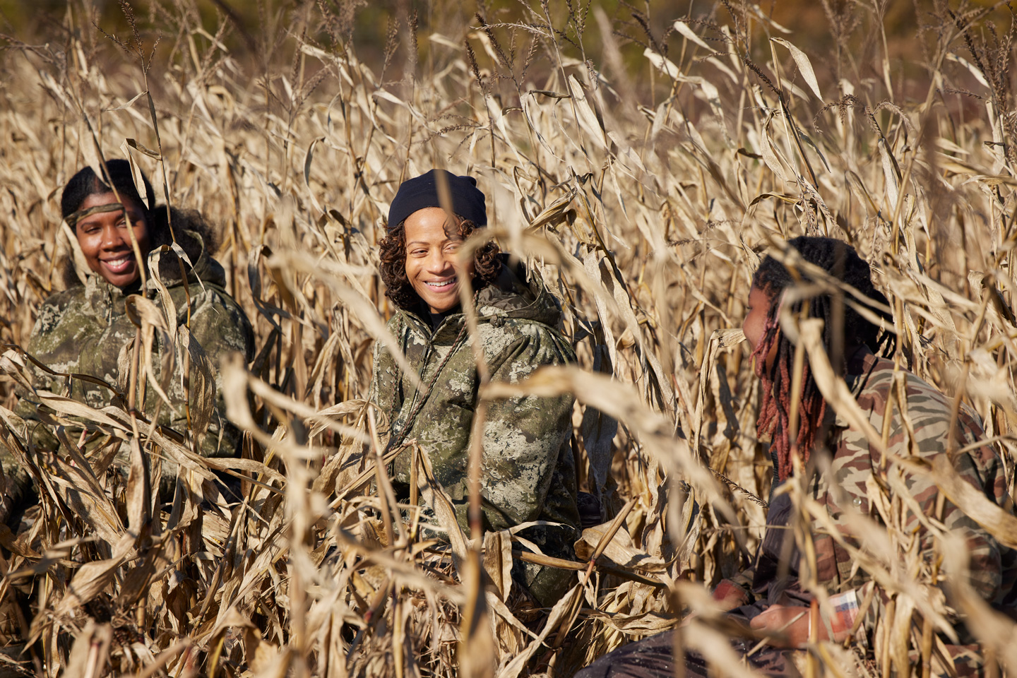 Three women in a cornfield.
