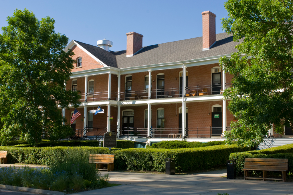 A brick two-story building with grand porches.