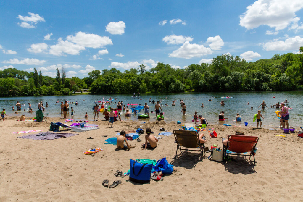People crowd a swim beach at Louisville State Recreation Area.