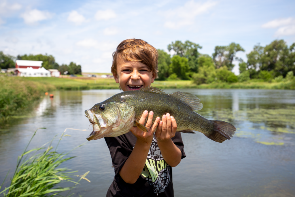 A boy with a large largemouth bass