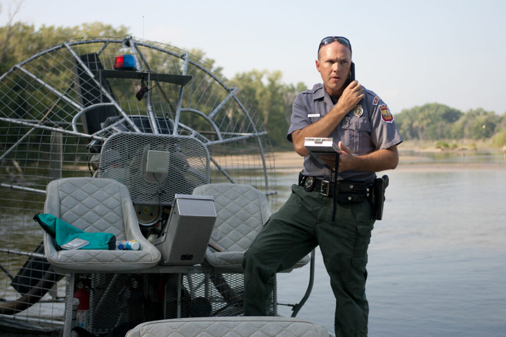 A conservation officer makes a phone call
