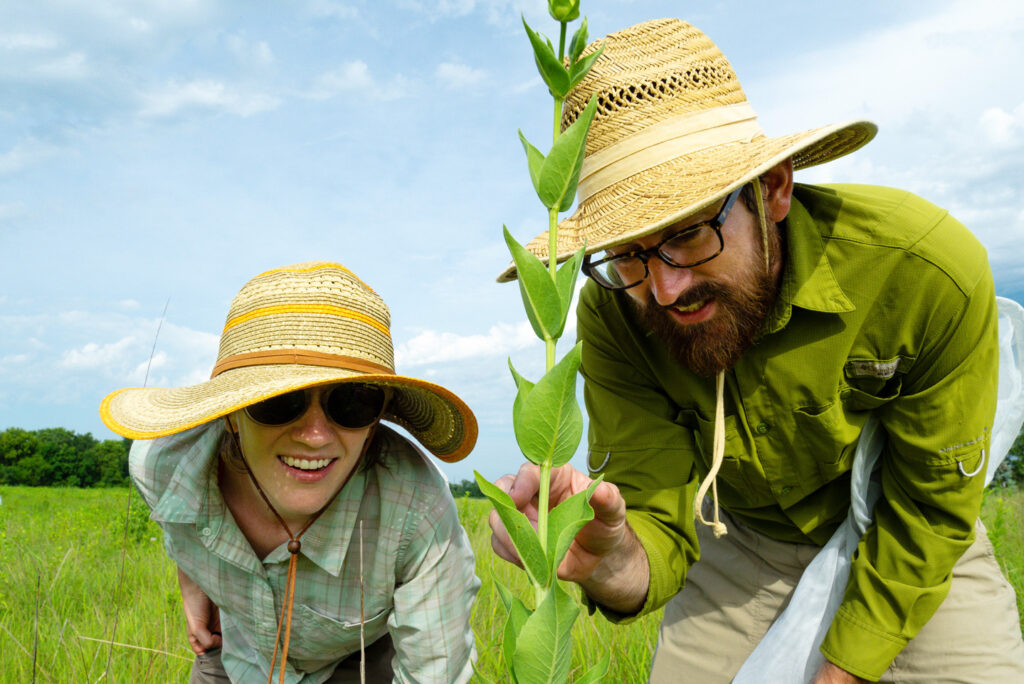 A man and woman identifying a plant.