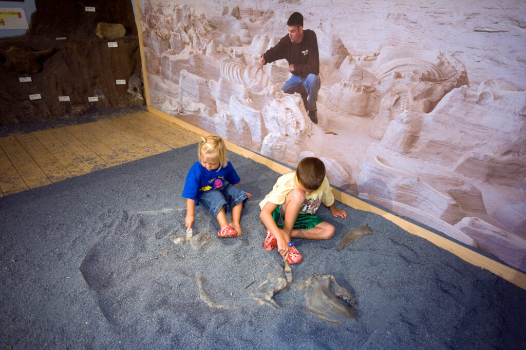 Kids playing on the interactive display at Ashfall State Historical Park.