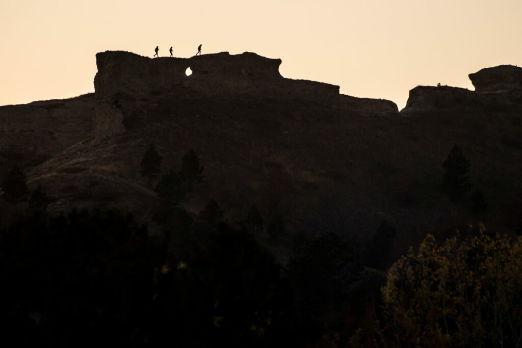 Hikers silhouetted on buttes at Chadron State Park