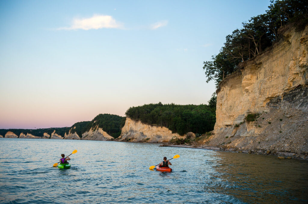 Lacey and Seth Gould of Wasau paddle their kayaks on Lewis and Clark Lake SRA, a reservoir on the Missouri River in Knox County, ast sunset.  Fowler, July 24, 2015. Copyright NEBRASKAland Magazine, Nebraska Game and Parks Commission.