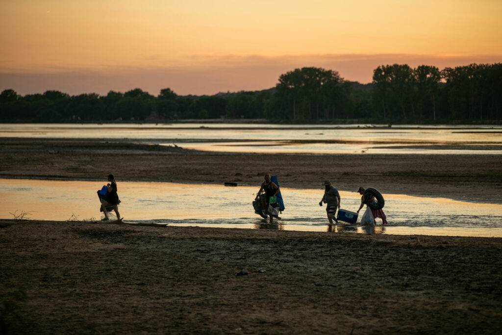 People playing and picnicking on the sandbars on the Platte River at Louisville State Recreation Area. Nguyen-Wheatley, June 27, 2020. Copyright Nebraskaland Magazine, Nebraska Game and Parks Commission.