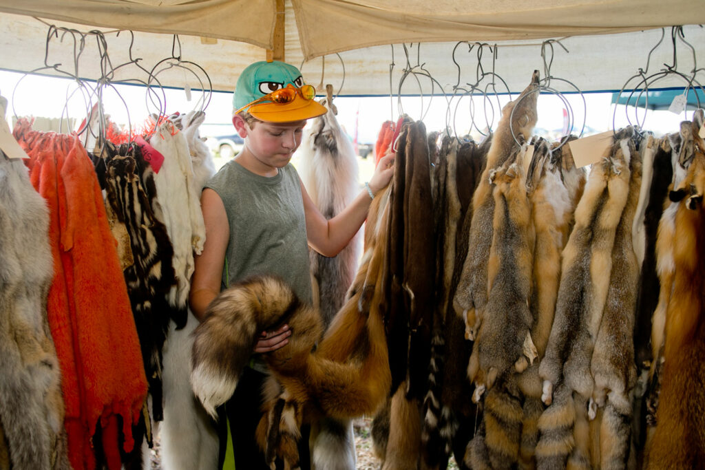 A boy looks at furs in a vendor tent at the Missouri River Outdoor Expo at Ponca State Park.