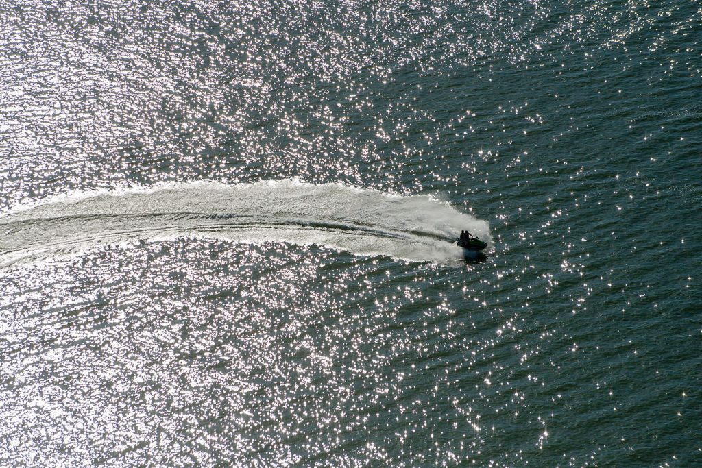 An aerial photo shows personal watercraft speeding across Lake Maloney SRA.