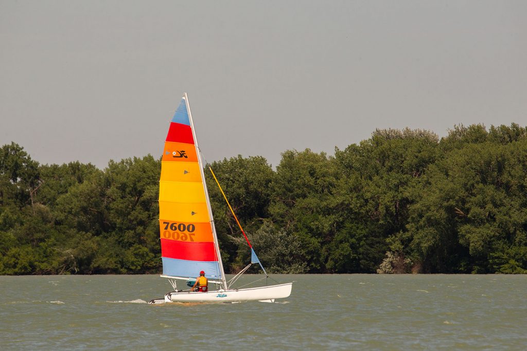 A colorful sailboat on a lake during summer