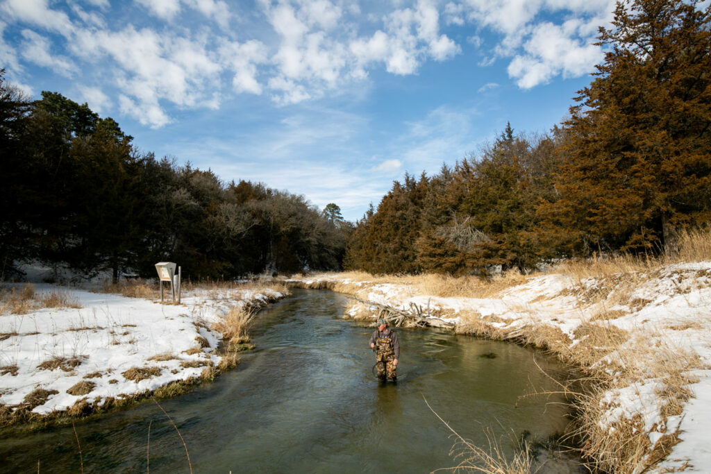 Rick Wheatley fishing for trout in Long Pine Creek at Long Pine State Recreation Area in Brown County during the winter. Nguyen, Feb. 03, 2015. Copyright NEBRASKAland Magazine, Nebraska Game and Parks Commission.