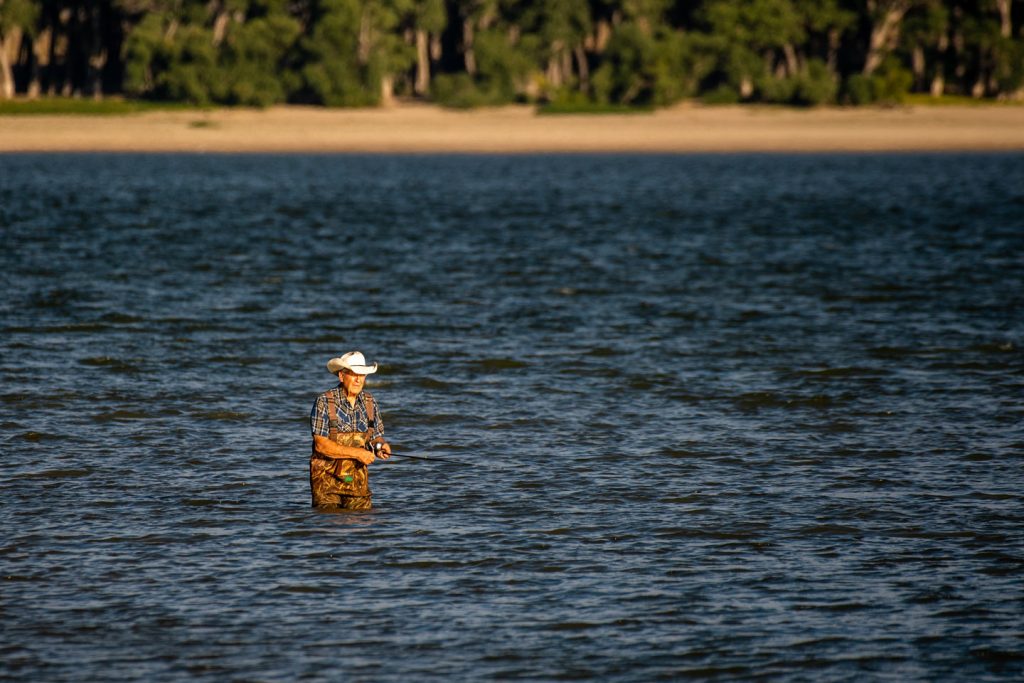 Fishing at Lake Minatare State Recreation Area in Scotts Bluff County. Ron Lowry of Lyman fishes in waders at Lake Minatare. Haag, Sept. 20, 2022. Copyright NEBRASKAland Magazine, Nebraska Game and Parks Commission.