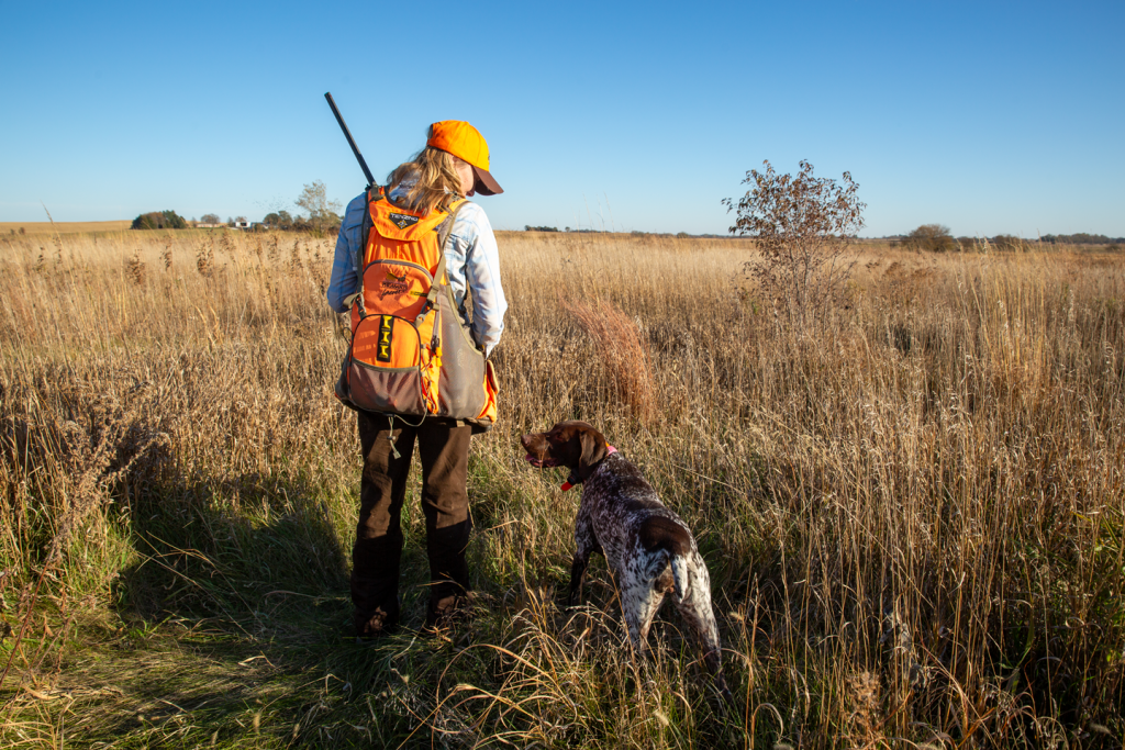 a woman and her dog hunting pheasants