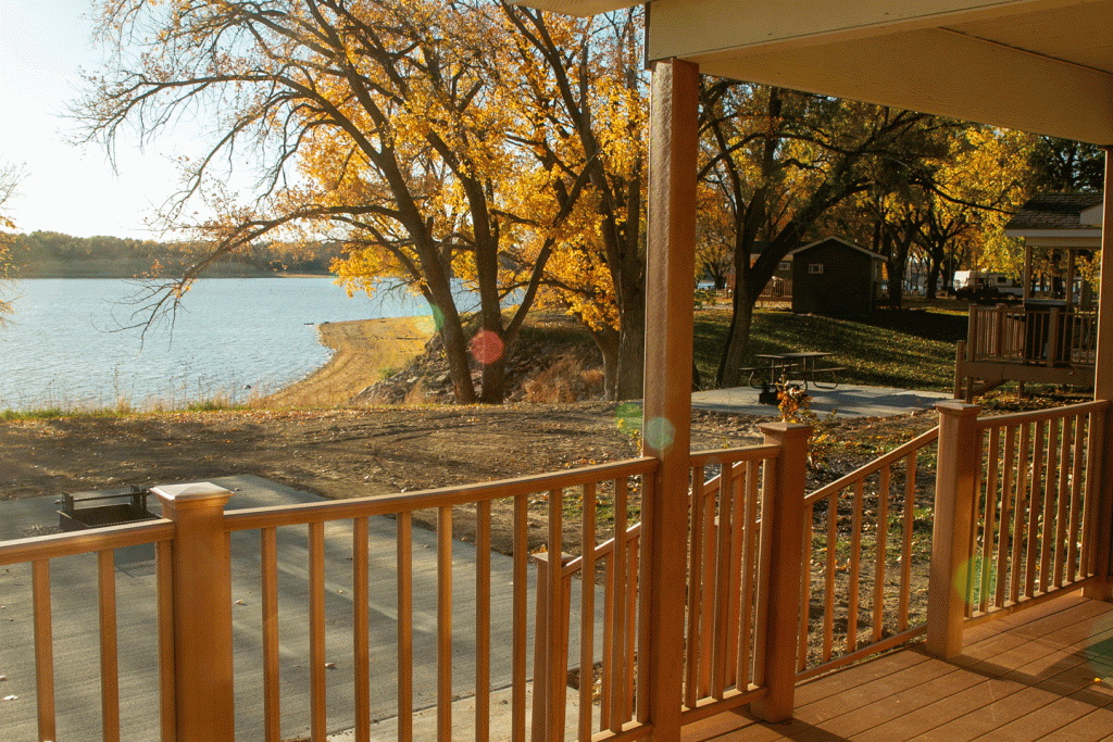 the view from the porch of a cabin toward a lake