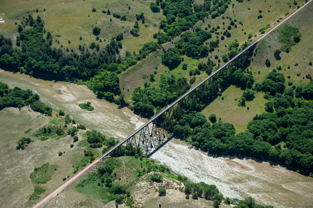 a long narrow bridge cuts across a river